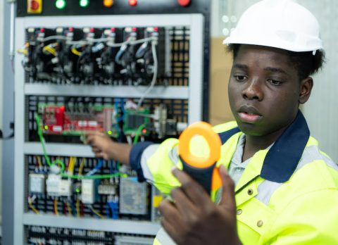 portrait-technician-working-with-digital-multimeter-test-electrical-system_159755-11474